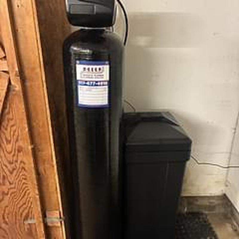 Water softener unit with brine tank in utility room