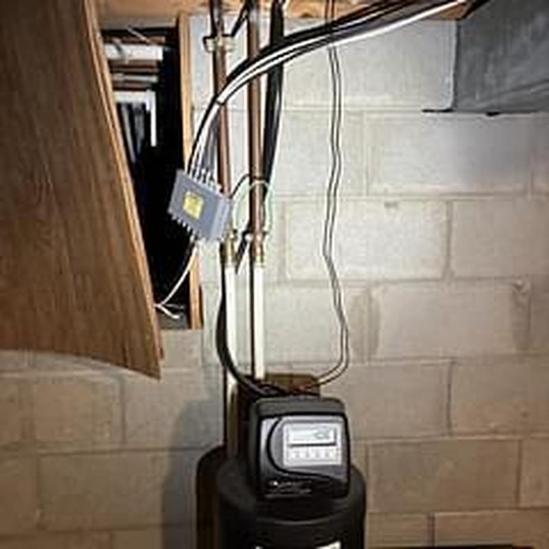 Water softener system with pressure valve adjustment in basement