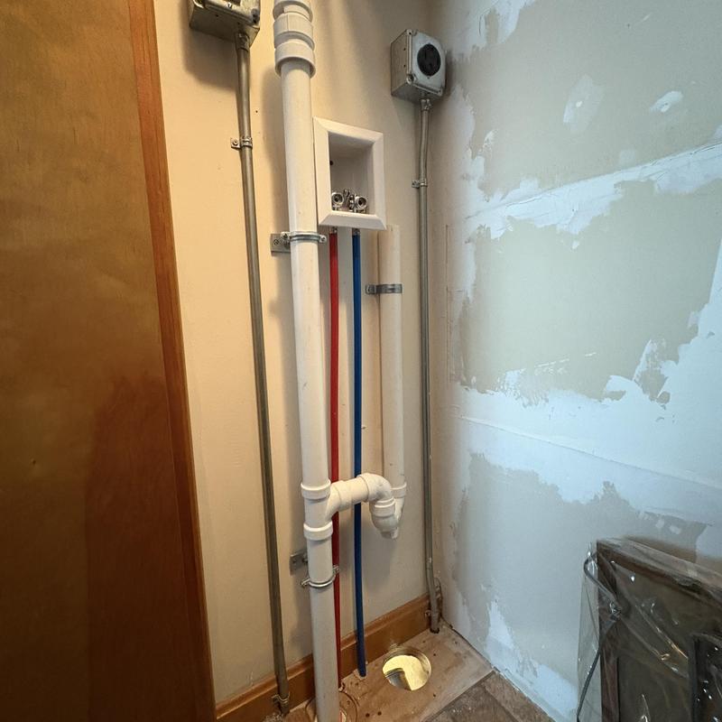 Laundry drain pipe and water supply lines reattached