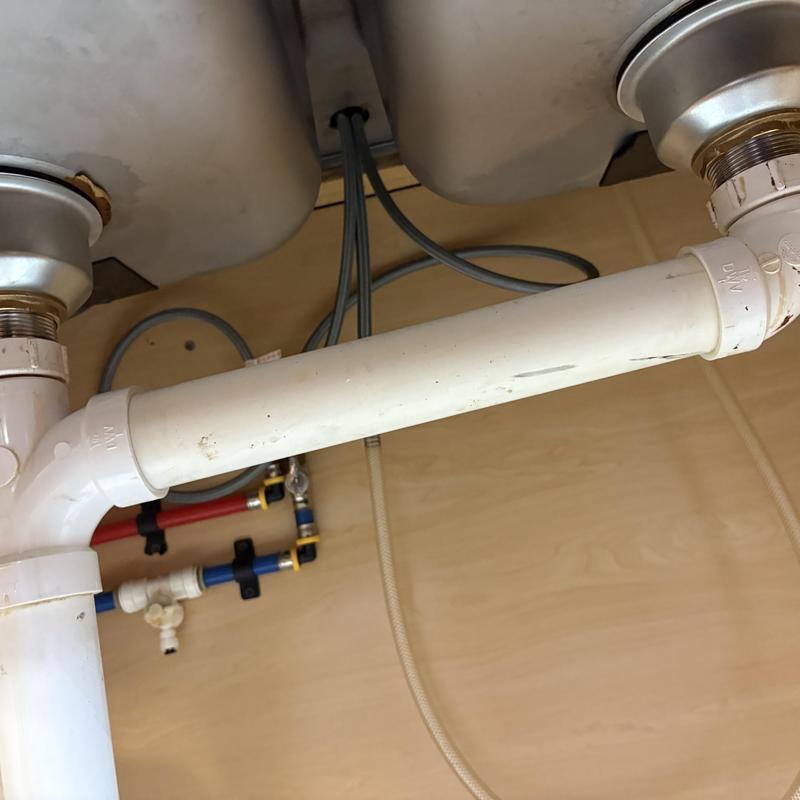 PVC plumbing drain pipe connected to double sink drains