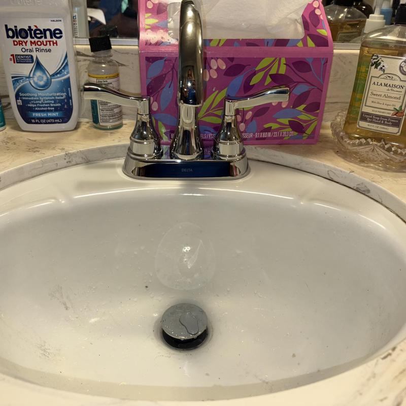 Delta bathroom faucet with pop-up assembly in sink Delta bathroom faucet with pop-up assembly in sink