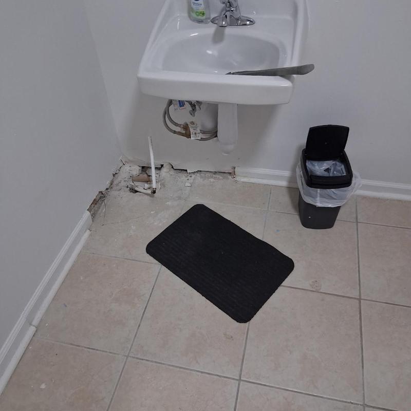 Bathroom sink plumbing with exposed pipes and damaged wall Bathroom sink plumbing with exposed pipes and damaged wall
