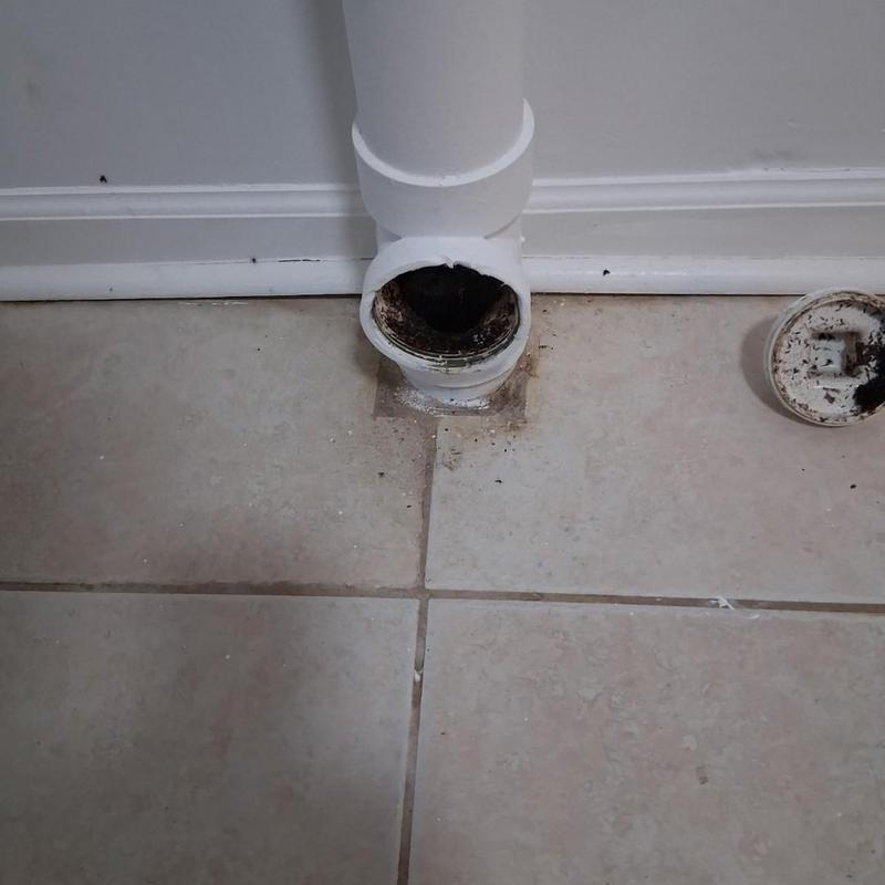 Floor drain pipe with removed cover on tile floor Floor drain pipe with removed cover on tile floor