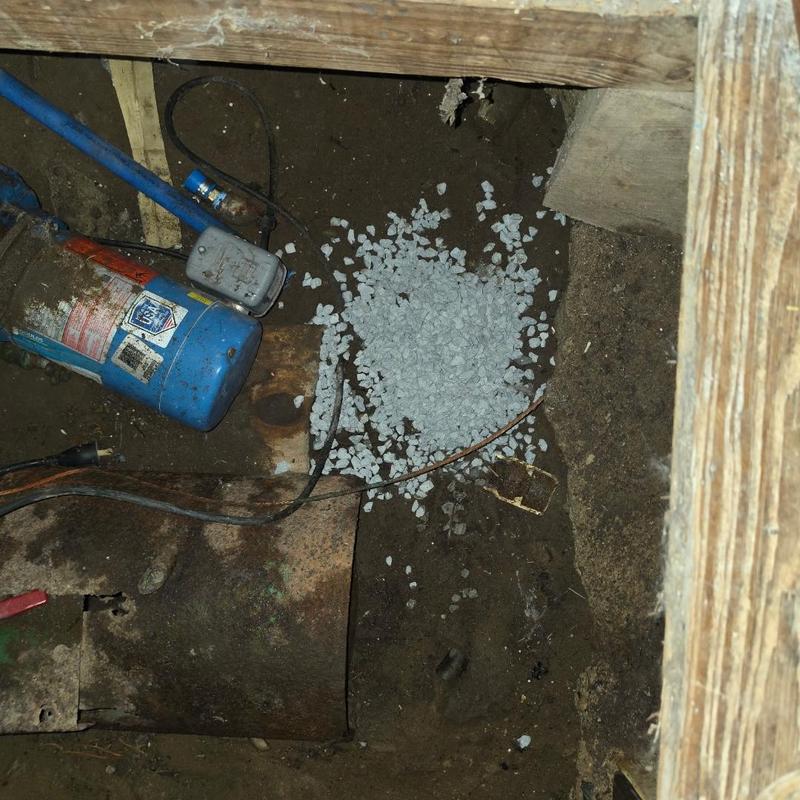 Shallow well head capped with gravel bed in pit Shallow well head capped with gravel bed in pit
