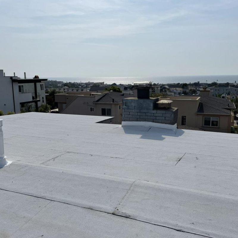 Flat roof membrane with chimney on residential building Flat roof membrane with chimney on residential building