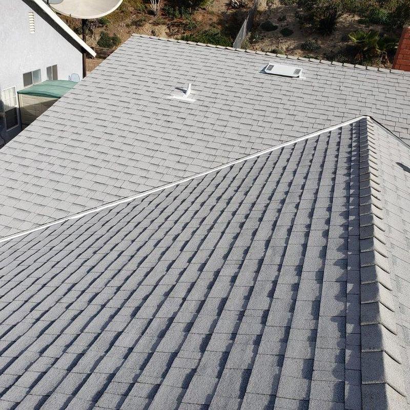 Gray shingle roof with vents on residential house Gray shingle roof with vents on residential house