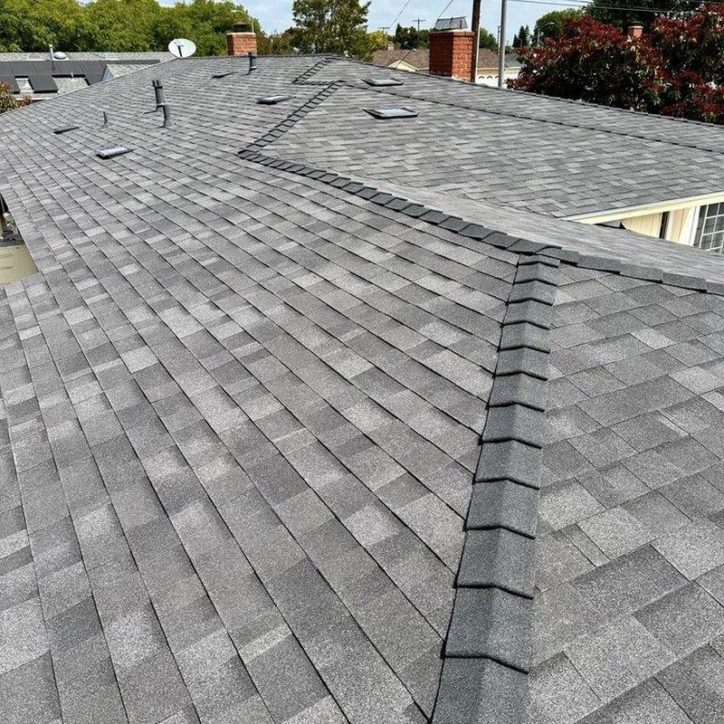 Asphalt shingle roof with new ridge cap installation Asphalt shingle roof with new ridge cap installation