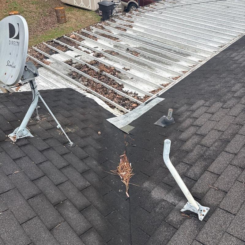 Asphalt shingle roof with metal roof debris buildup