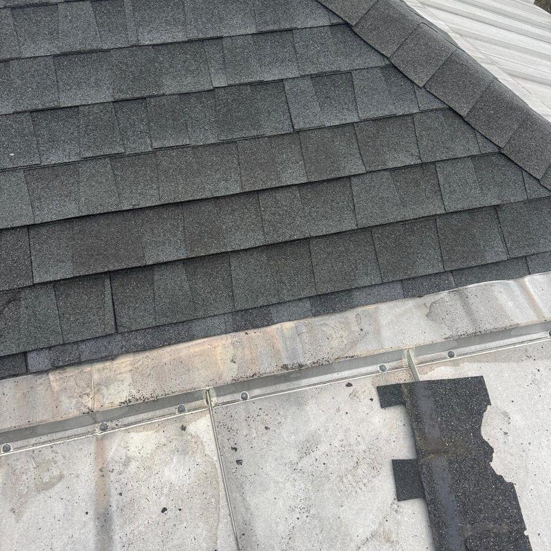 Roof shingles and metal flashing with hail damage