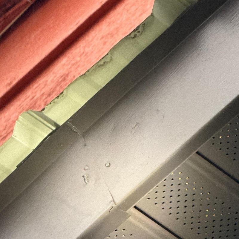 Metal roof flashing with hail damage and sealing issues