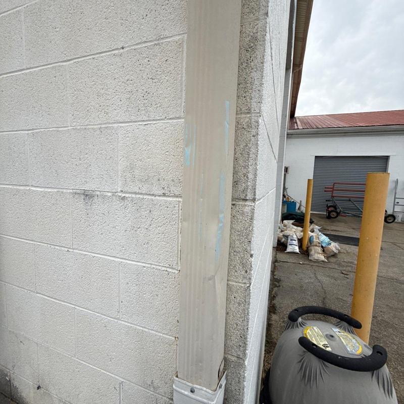 Downspout and building corner with minor wear marks
