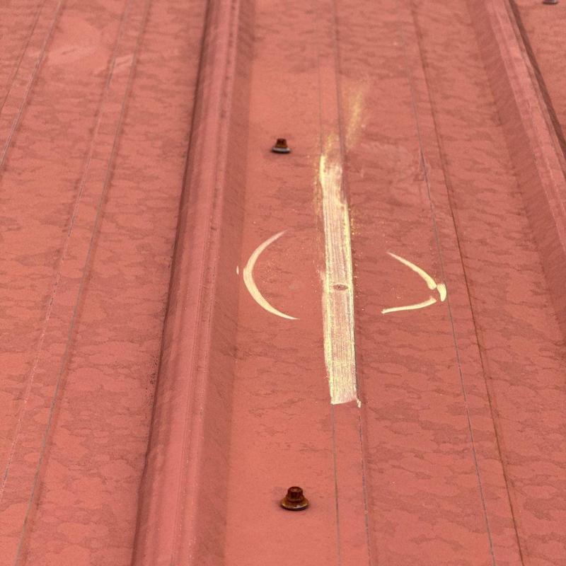 Metal roofing panel dent and hail damage inspection marks
