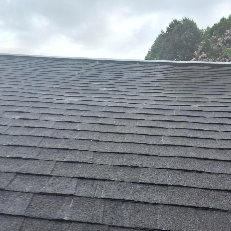 Asphalt shingle roof with visible wear and leak spots