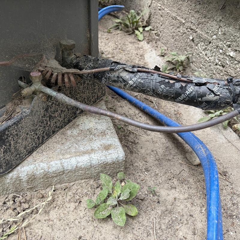 Refrigerant line and outdoor AC condenser base in dirt
