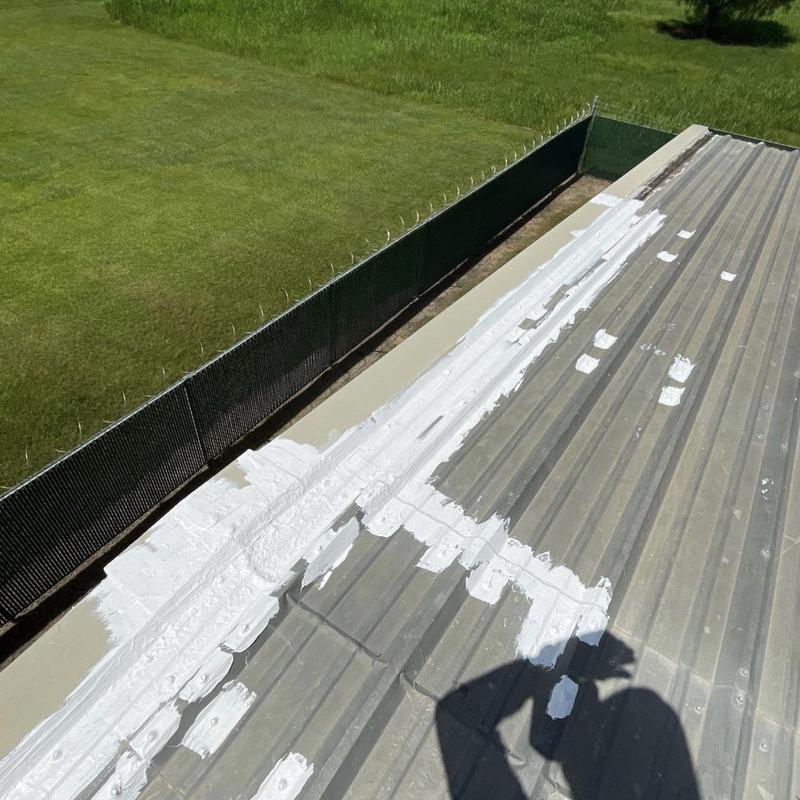 Metal roof panel seam sealing with white sealant Metal roof panel seam sealing with white sealant