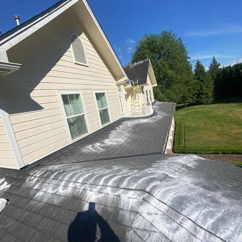 Asphalt shingle roof with cleaning residue on surface