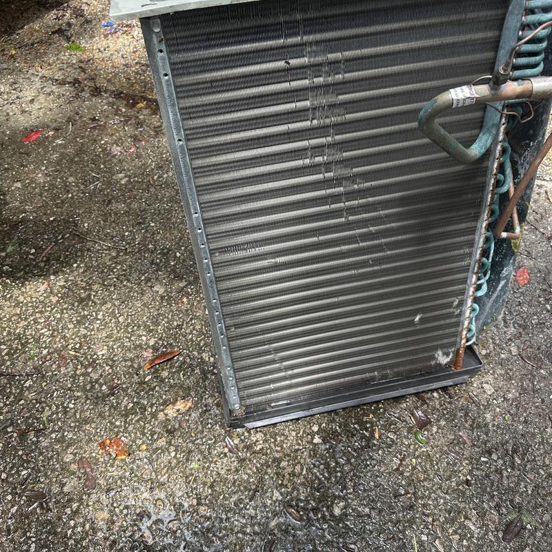 HVAC condenser coil removed and ready for cleaning