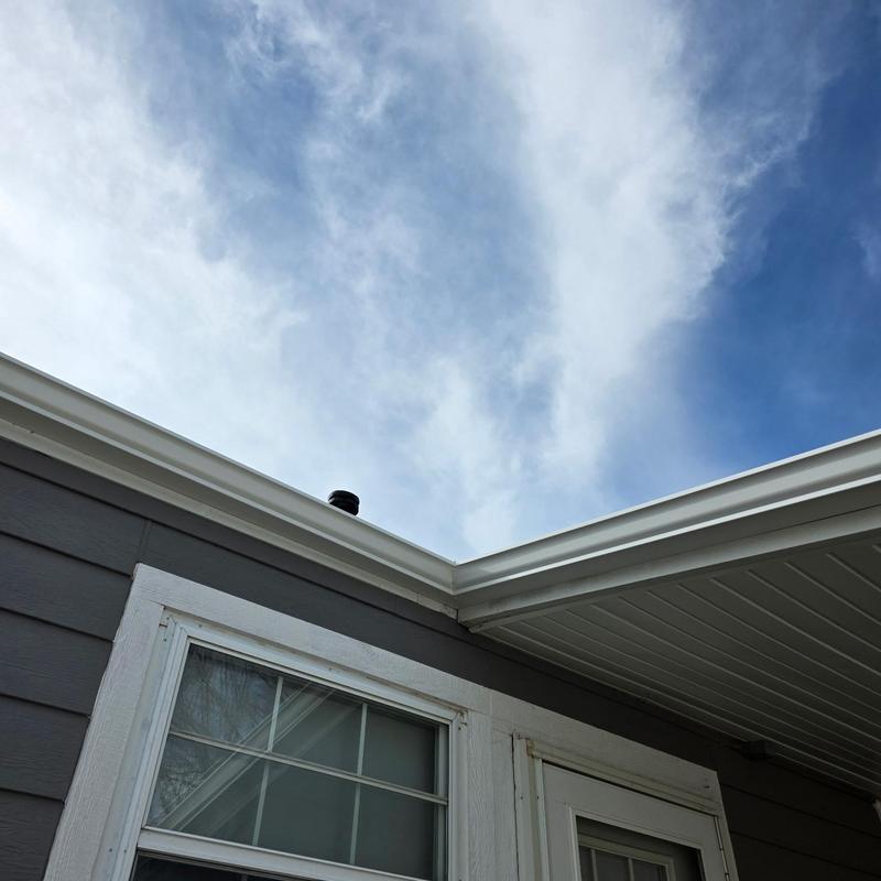 Aluminum gutters on home exterior corner under roofline Aluminum gutters on home exterior corner under roofline
