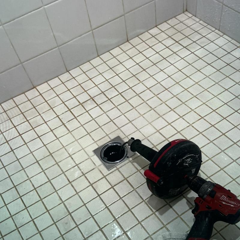Shower drain snaking with plumbing auger tool