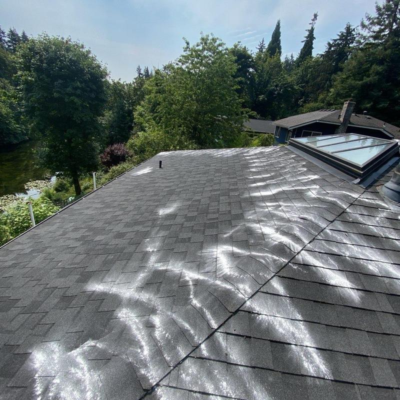 Roof shingles with reflective sunlight patterns on surface