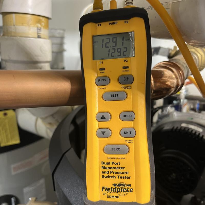 Pressure switch tester measuring gas pressure on water heater Pressure switch tester measuring gas pressure on water heater