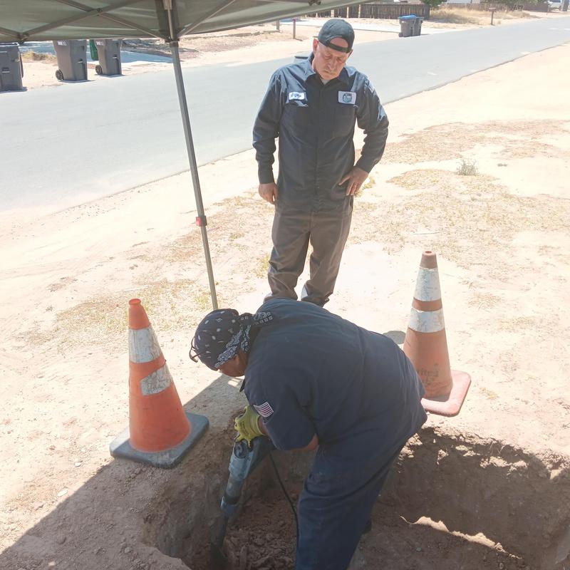 Sewer pipe spot repair with excavation and safety cones Sewer pipe spot repair with excavation and safety cones