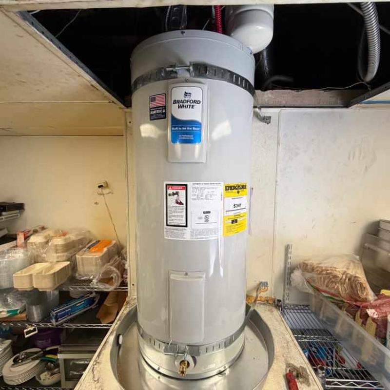 Electric water heater with new drain pan installed