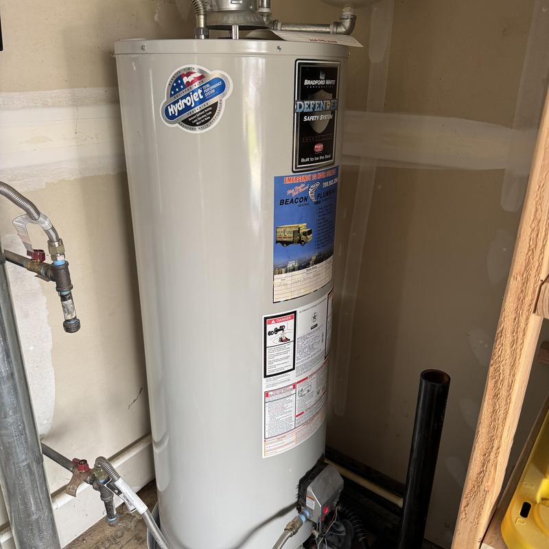 Water heater flushing and safety inspection in utility room