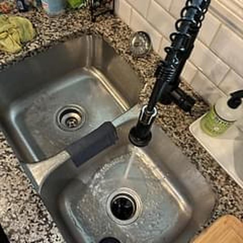 Kitchen sink drain with running water and spray faucet