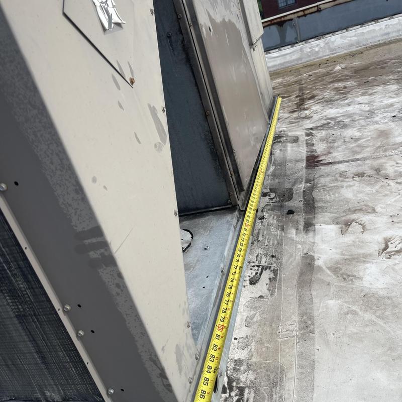 RTU unit measurement with tape on rooftop