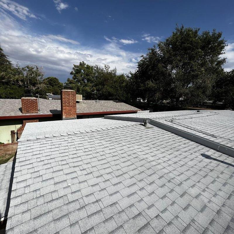 Shingle roof with chimney and vent pipe, inspection view Shingle roof with chimney and vent pipe, inspection view