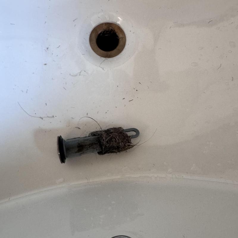 Bathtub drain stopper with hair clog debris removed Bathtub drain stopper with hair clog debris removed