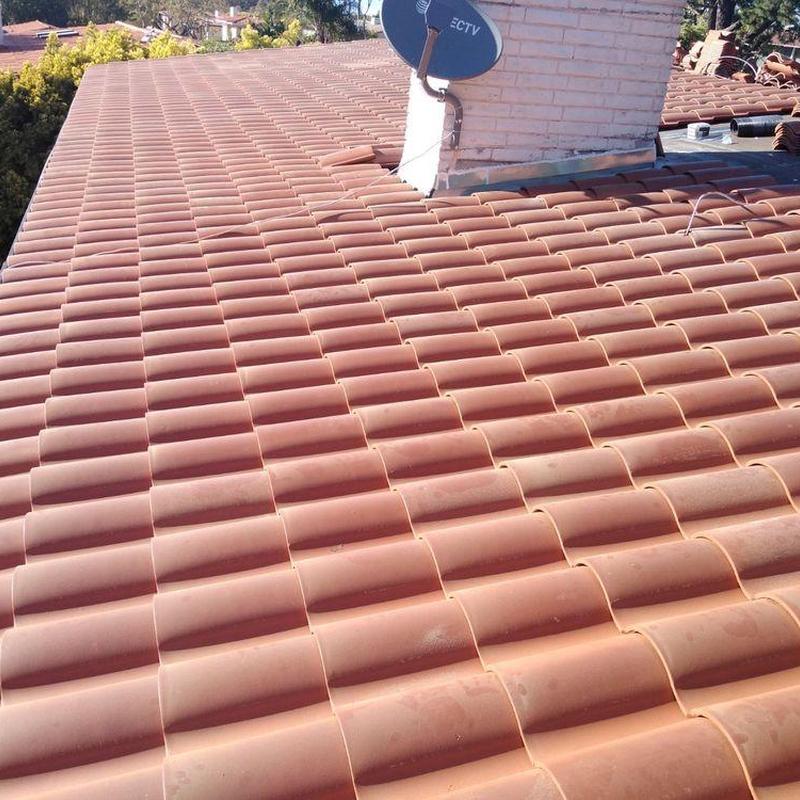 Tile roof with chimney and satellite installation Tile roof with chimney and satellite installation