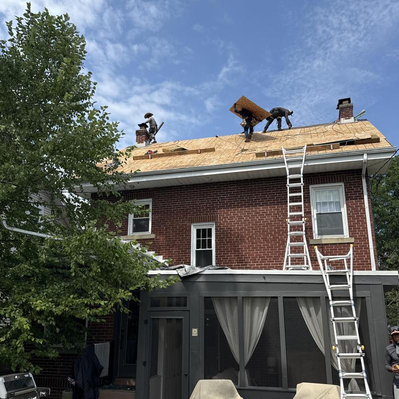 Synthetic slate roof decking installation on brick home