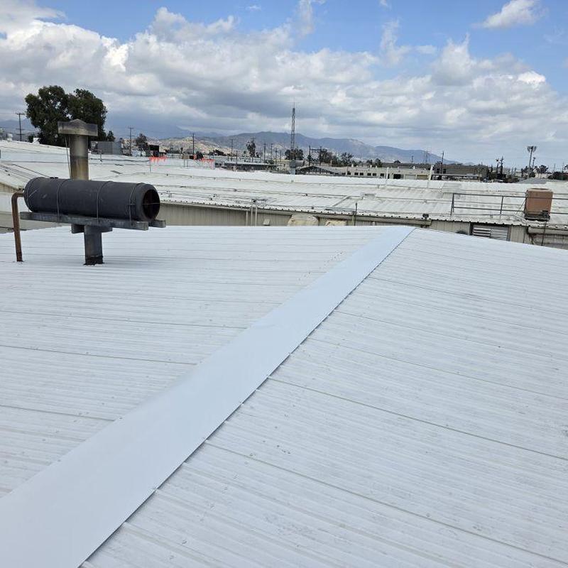 Metal commercial roof with vent pipe and ridge cap Metal commercial roof with vent pipe and ridge cap