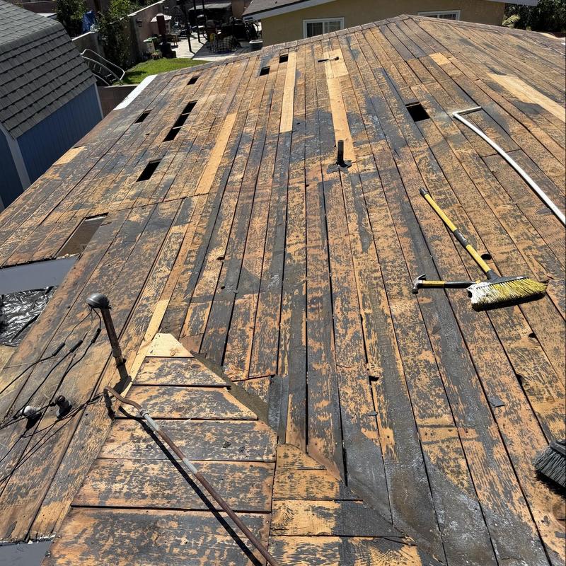 Wooden roof decking with worn protective coating removal Wooden roof decking with worn protective coating removal