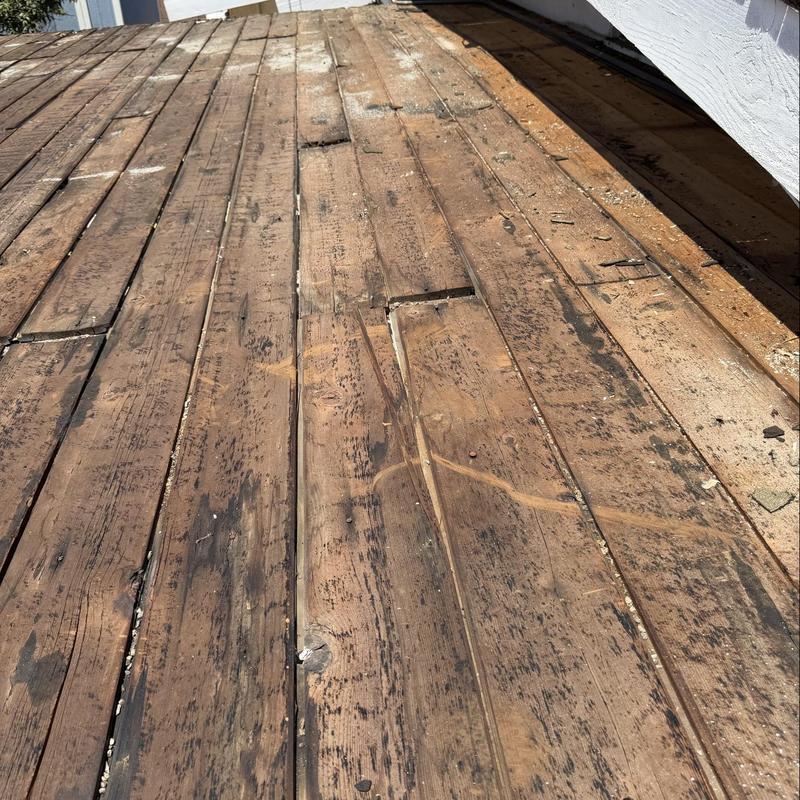 Wooden roof decking with weather and damage signs Wooden roof decking with weather and damage signs