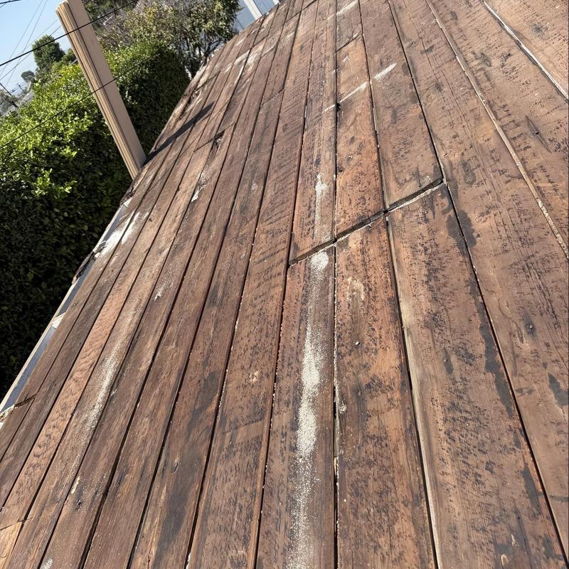 Wooden roof deck with water damage and wear signs Wooden roof deck with water damage and wear signs