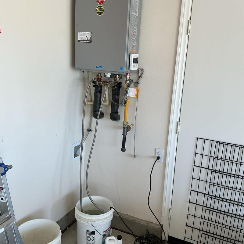 Tankless water heater with flushing lines in garage Tankless water heater with flushing lines in garage