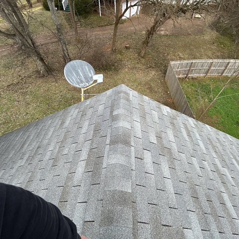 Asphalt shingle roof ridge with hail damage inspection