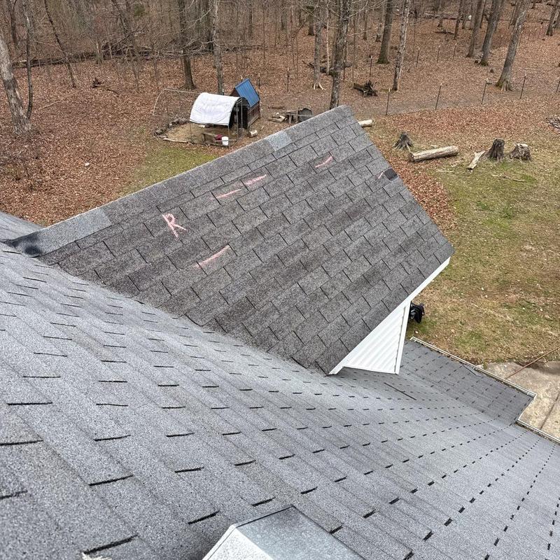 Asphalt shingle roof with hail damage marked for repair