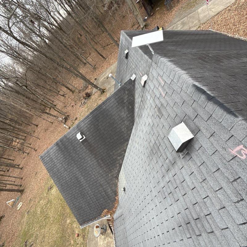 Asphalt shingle roof with vents and hail damage markings