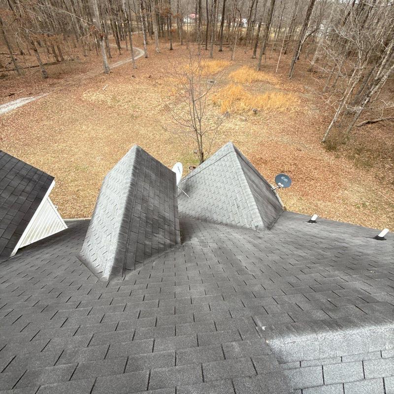 Asphalt shingle roof with chimney flashing inspection
