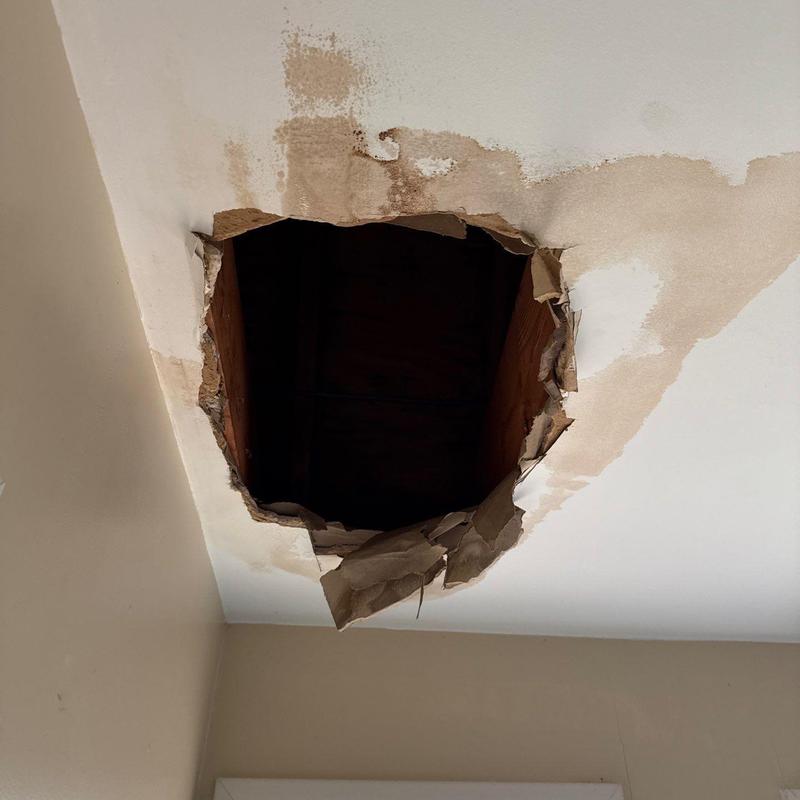 Ceiling drywall with large water damage hole
