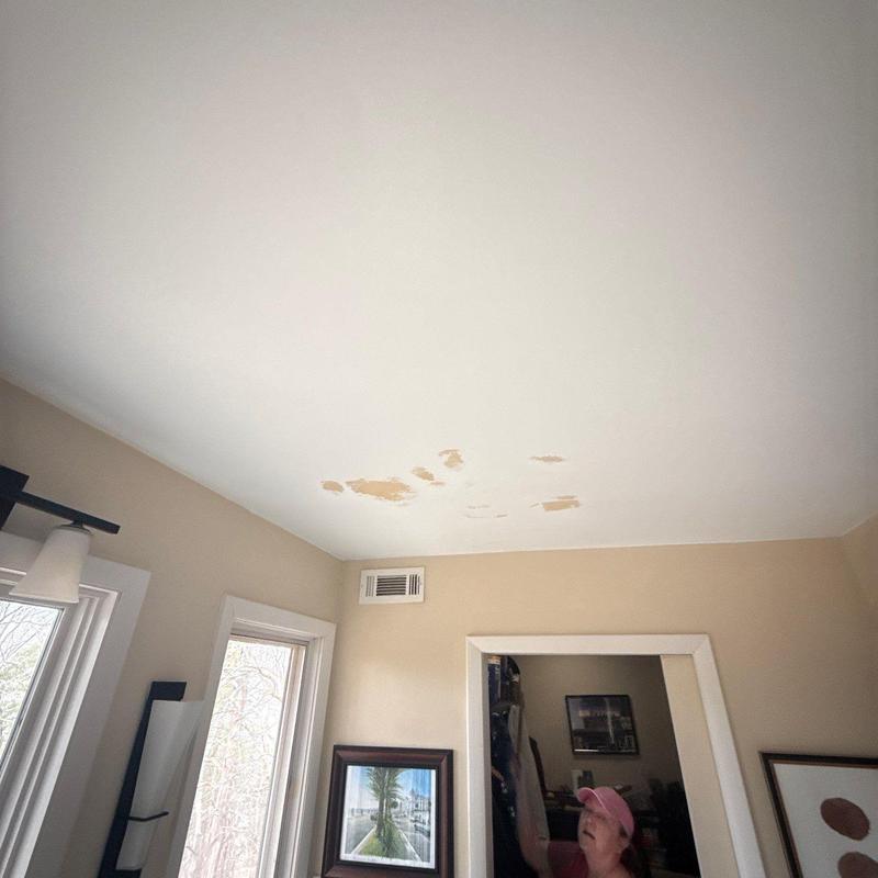 Ceiling paint damage with water stains interior room