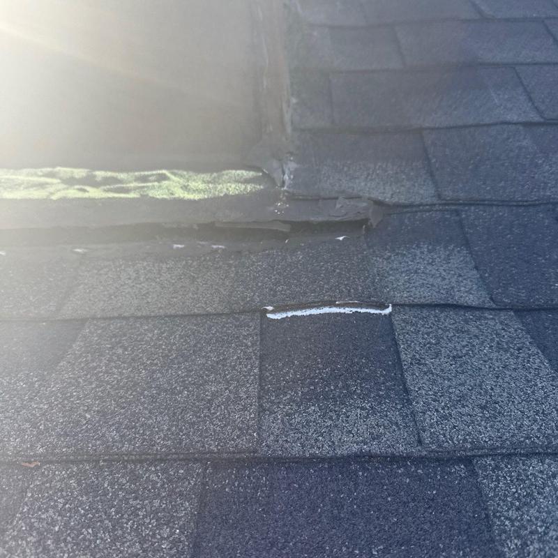 Shingle roofing with hail damage near flashing