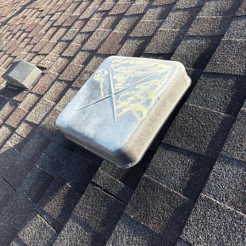 Roof vent with hail damage on asphalt shingles