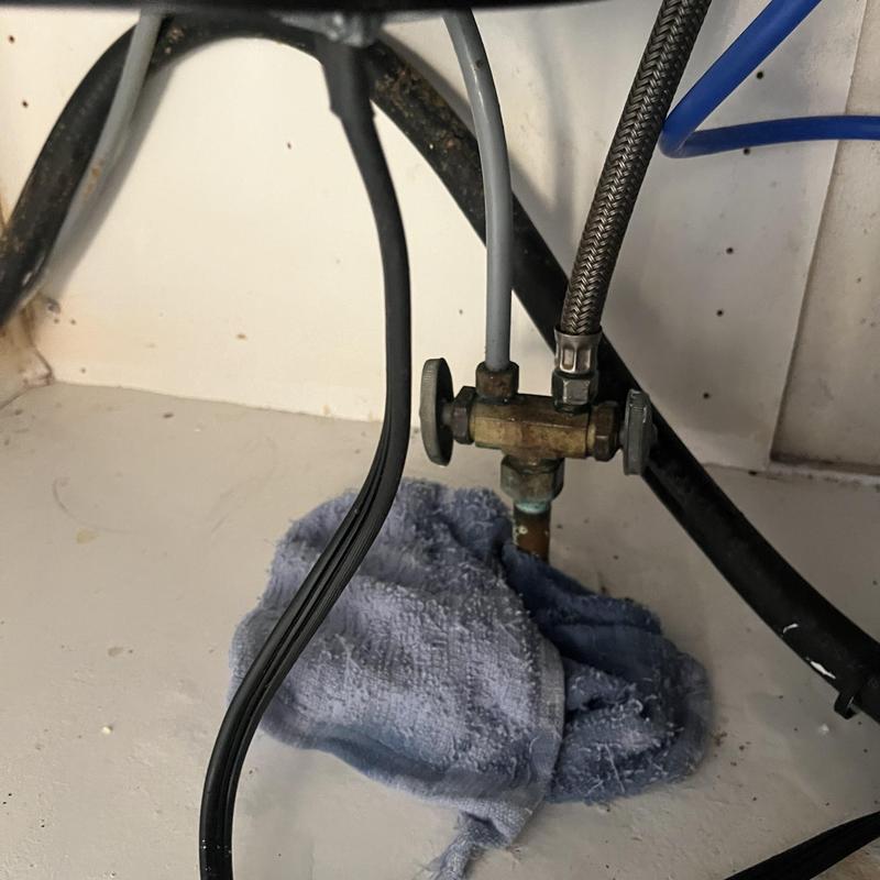 Dual stop valve with leaky washer under kitchen sink Dual stop valve with leaky washer under kitchen sink