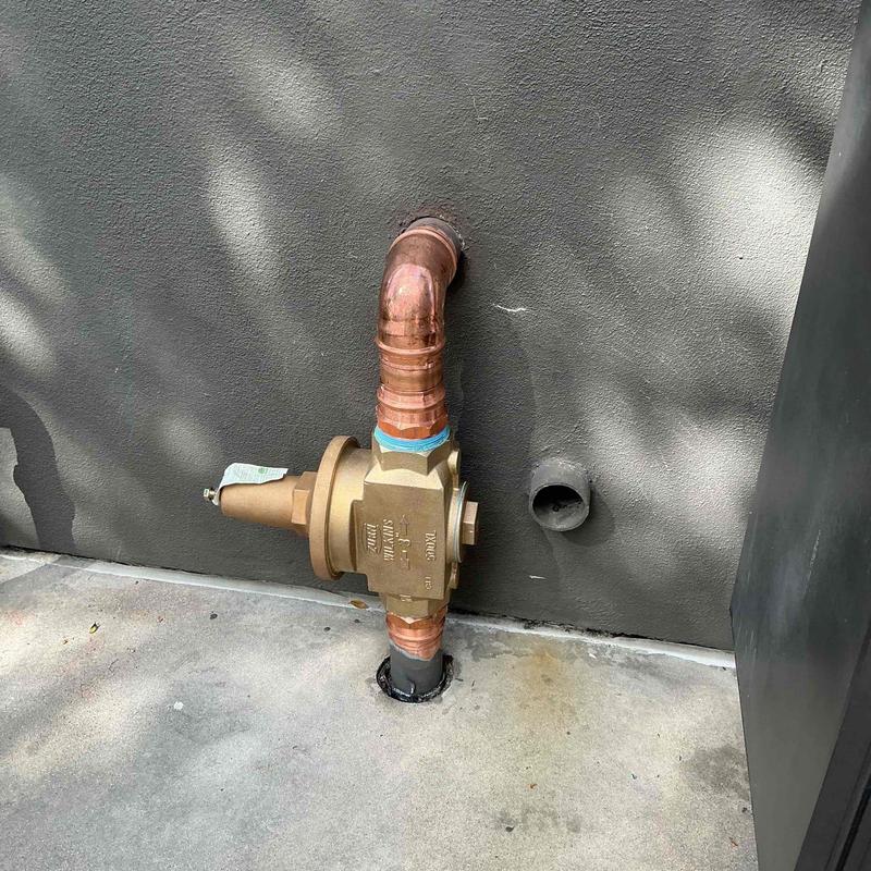 Copper plumbing pressure regulator installation near wall Copper plumbing pressure regulator installation near wall