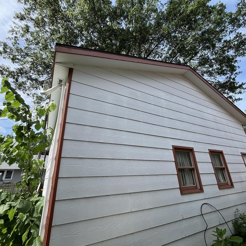 Aluminum gutters on white sided house exterior Aluminum gutters on white sided house exterior
